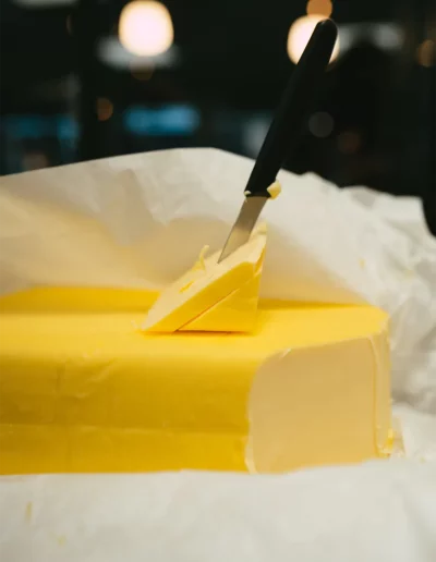 Mise en scène d'un couteau planter dans une grosse motte de beurre, réalisée par un photographe à Annecy